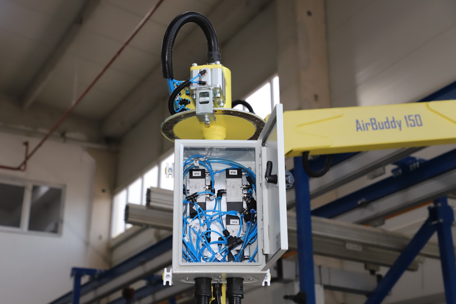 A Soyerpek industrial manipulator precisely handling a part in a factory setting.